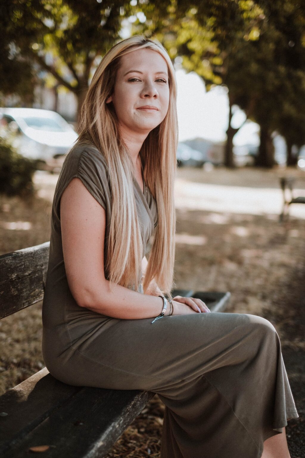 Danielle Hunter sitting on a park bench under the trees